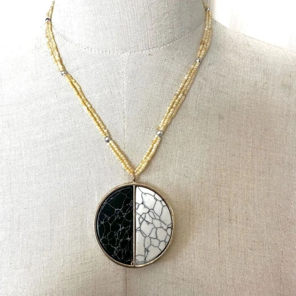 White  black and gold tone circle stone beaded pendant necklace
